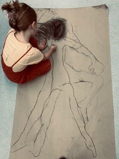 Girl drawing with charcoal