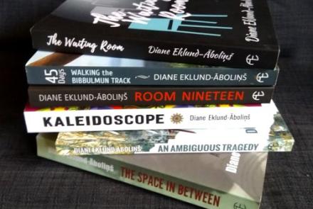 A stack of books written by Diane Eklund-Abolins
