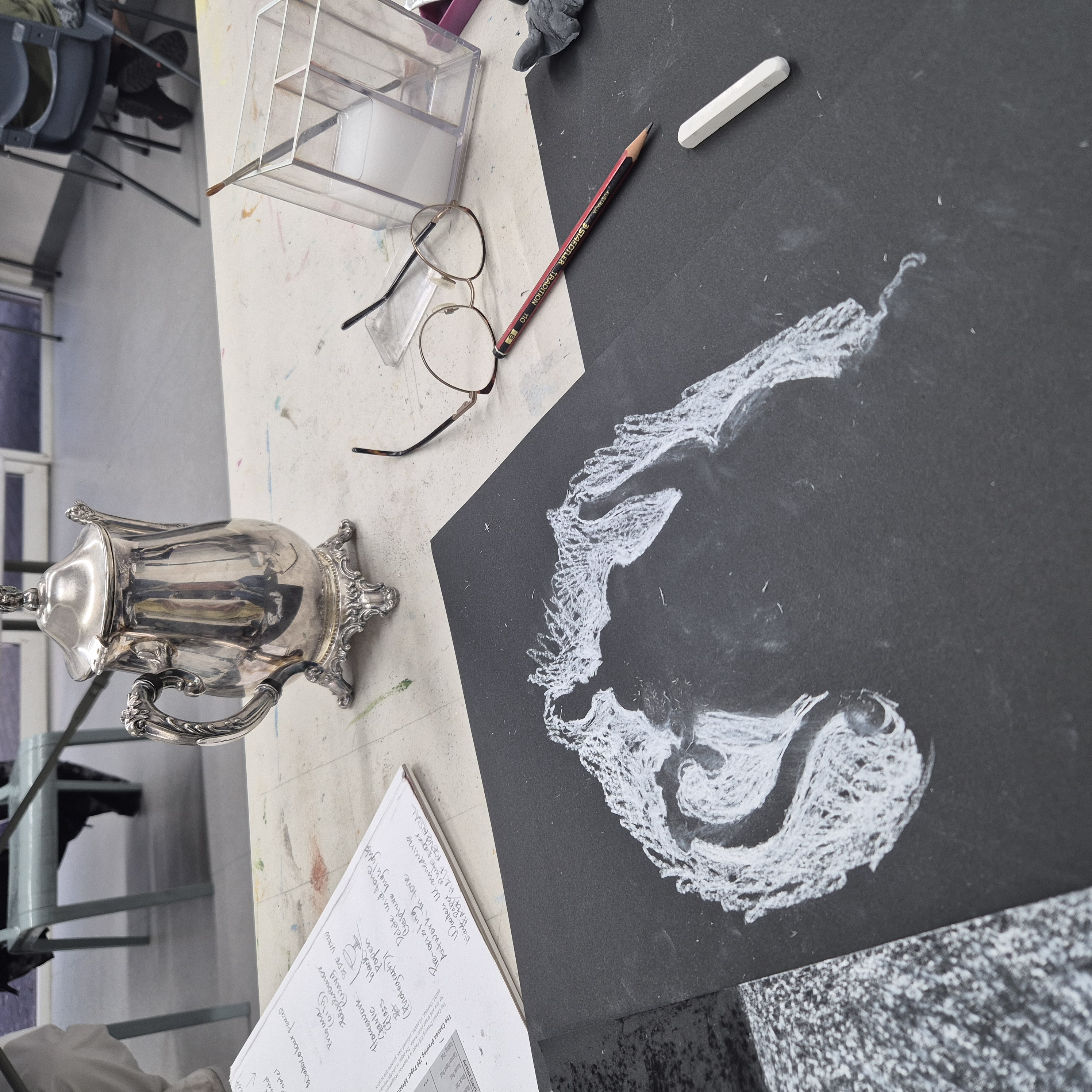 Teapot silhouette on black paper