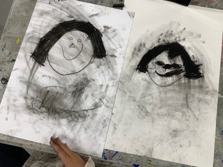 Charcoal drawing of a faces