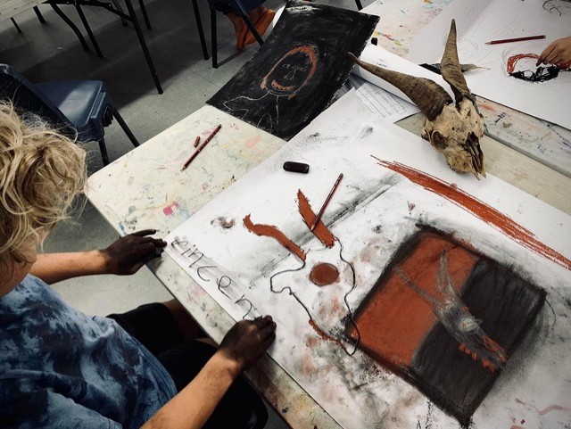 Boy drawing with charcoal