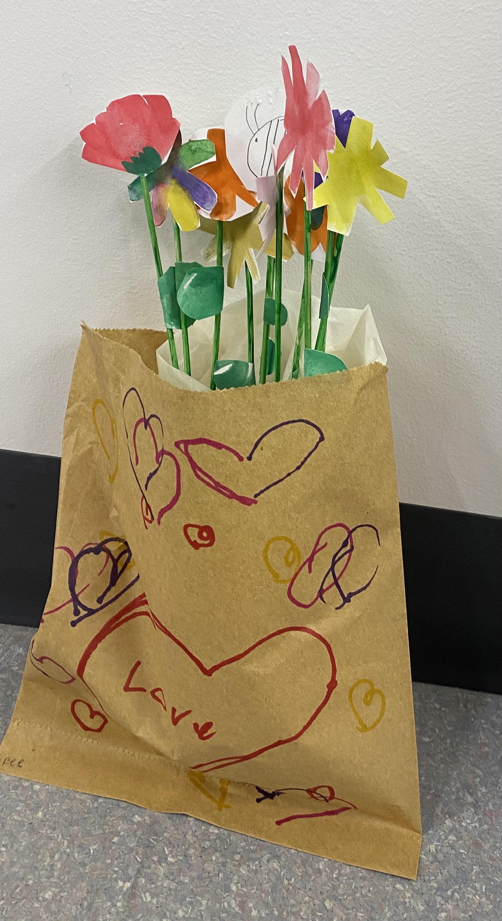 Watercolour flowers, cut out and placed inside a bag with drawn hearts