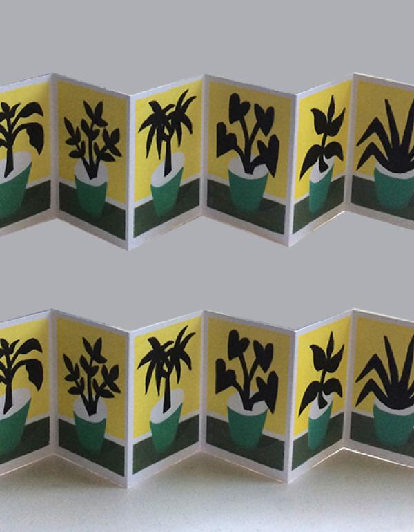 Yellow folded card with flower silhouettes