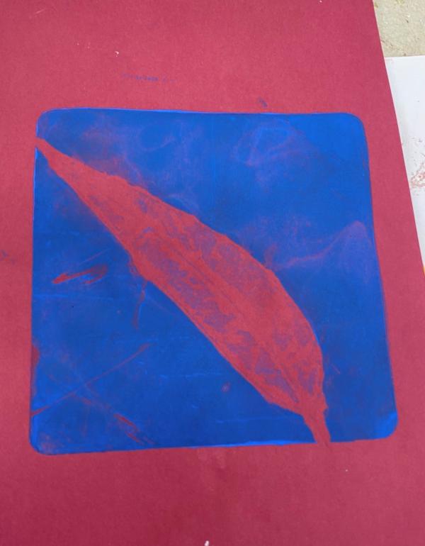 Screen print of a red gum leaf on a blue background