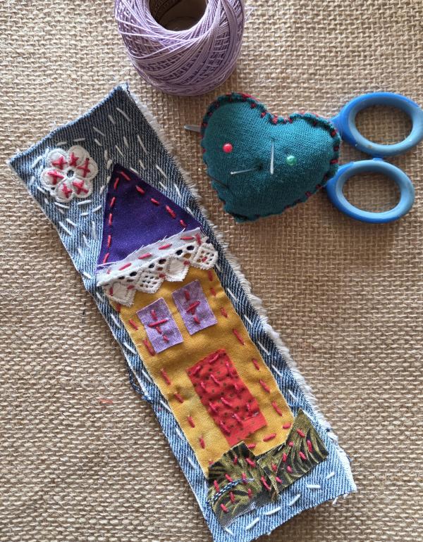 Textile bookmark with house stitched in fabric