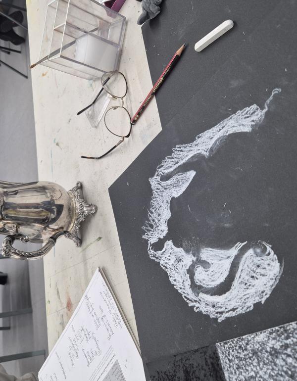 Teapot silhouette on black paper