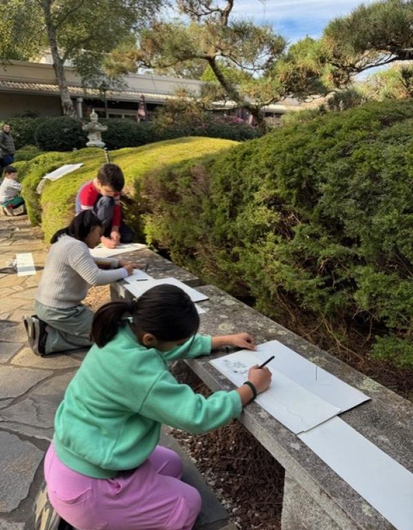 Children drawing in the garden