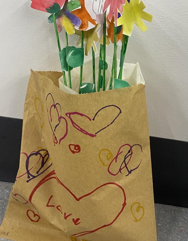 Watercolour flowers, cut out and placed inside a bag with drawn hearts