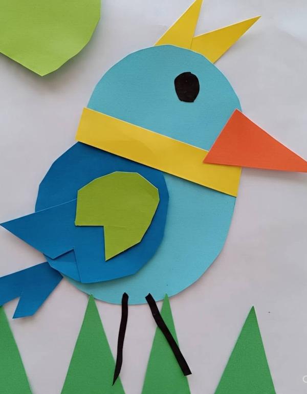 Different shapes (blue, orange, yellow and green) put together to make a bird.